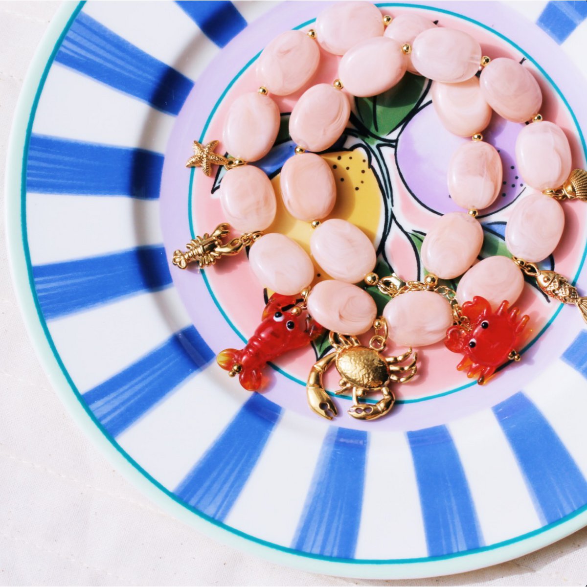 Oval beaded necklace with "Crabby's" charms