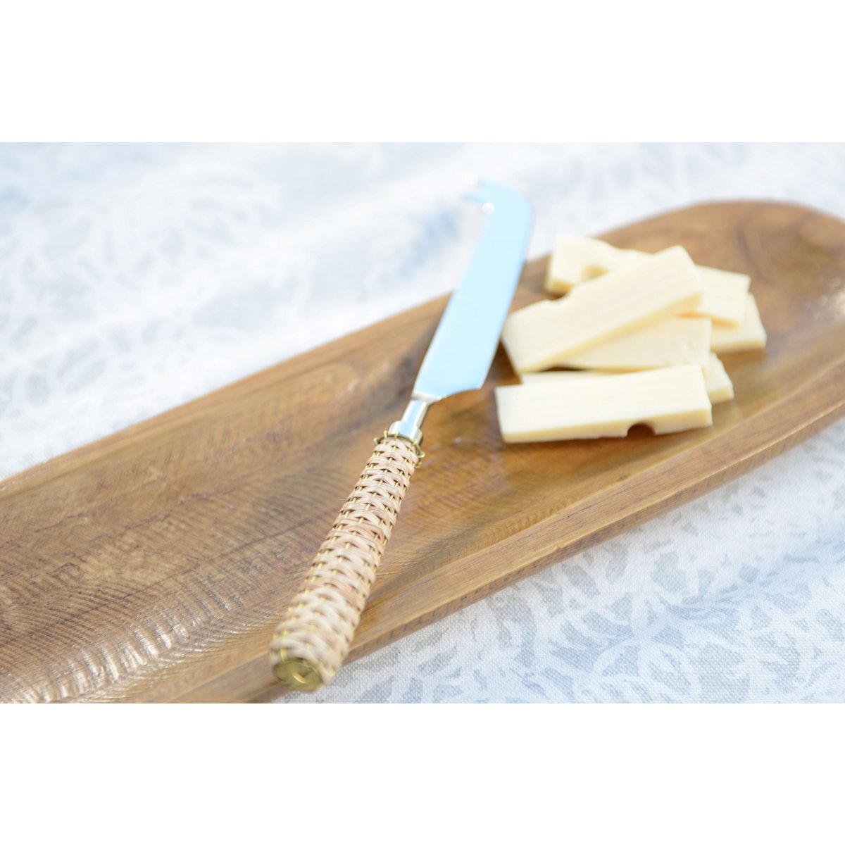 Beige cheese knife with wicker handle