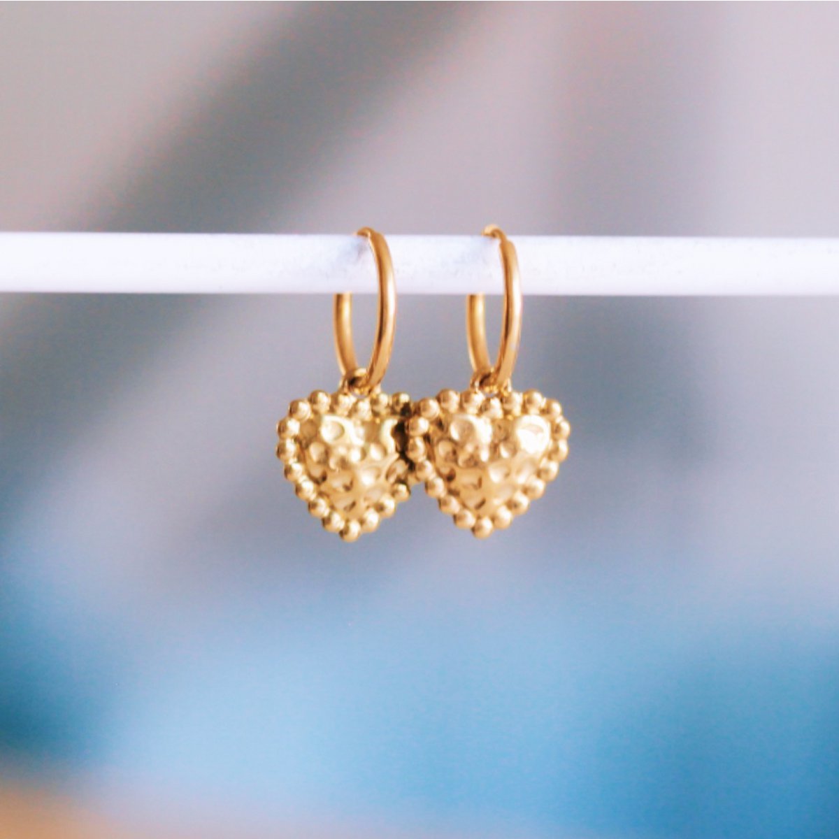 Stainless steel hoop earrings with a dotted heart