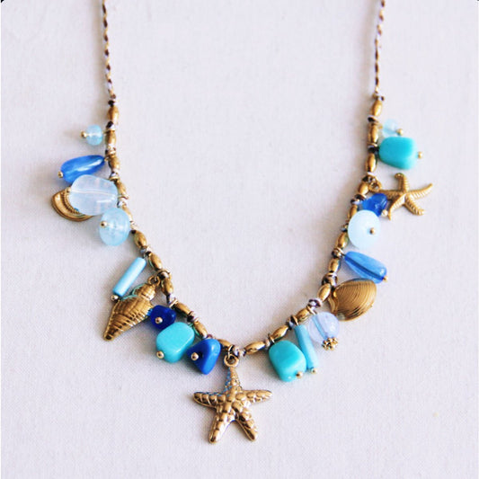 Braided necklace with shell charms and mint/blue stones