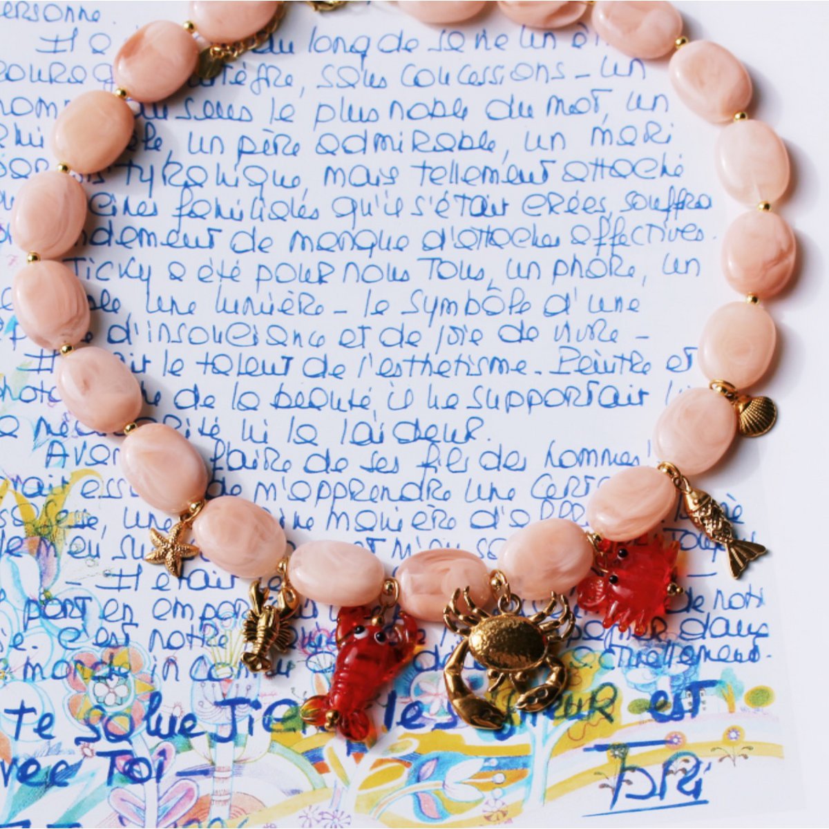 Oval beaded necklace with "Crabby's" charms