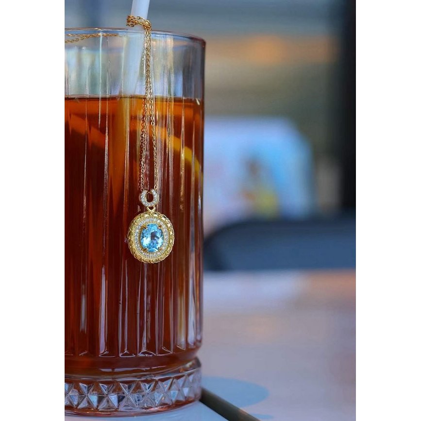 Blue Topaz Gold Framed Oval Pendant Necklace