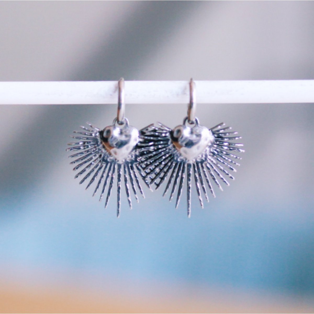Stainless steel hoop earrings with a heart and rays – silver