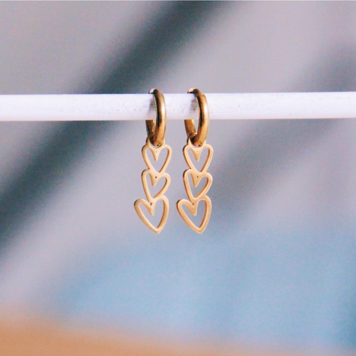 Stainless steel hoops with 3 angled hearts - gold