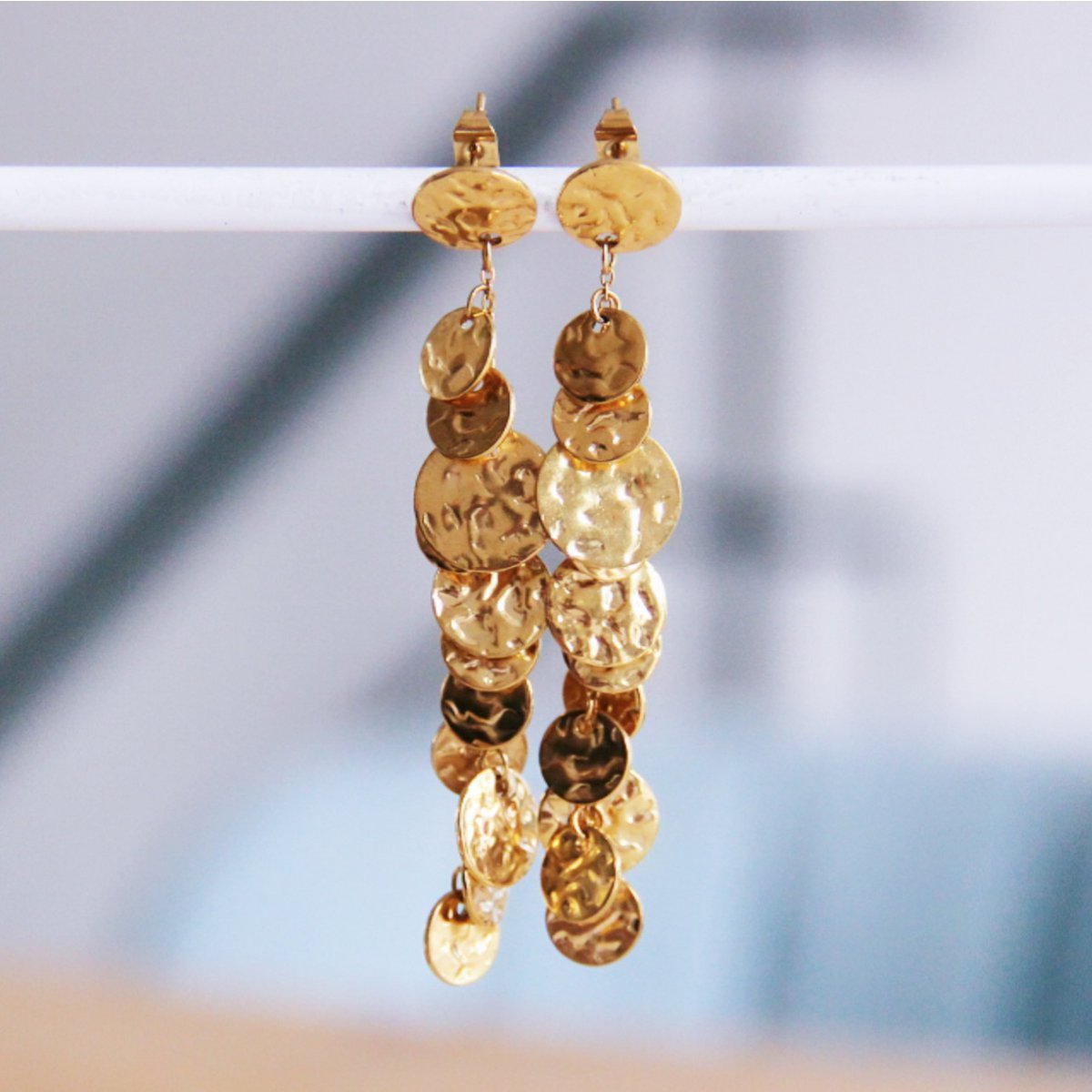Stud earrings with a chain of coins