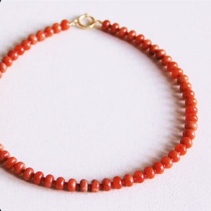 Beaded necklace of natural stone donuts - orange/red