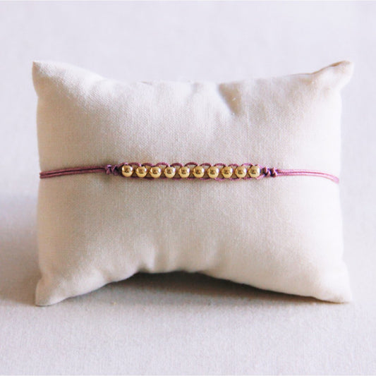 Satin bracelet with gold-colored beads - lilac