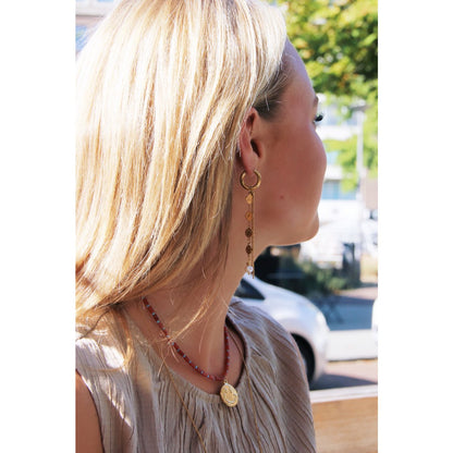 Stainless steel hoop earring with coins, pearl, and strings