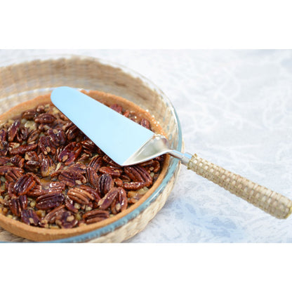 Beige pie shovel with wicker handle