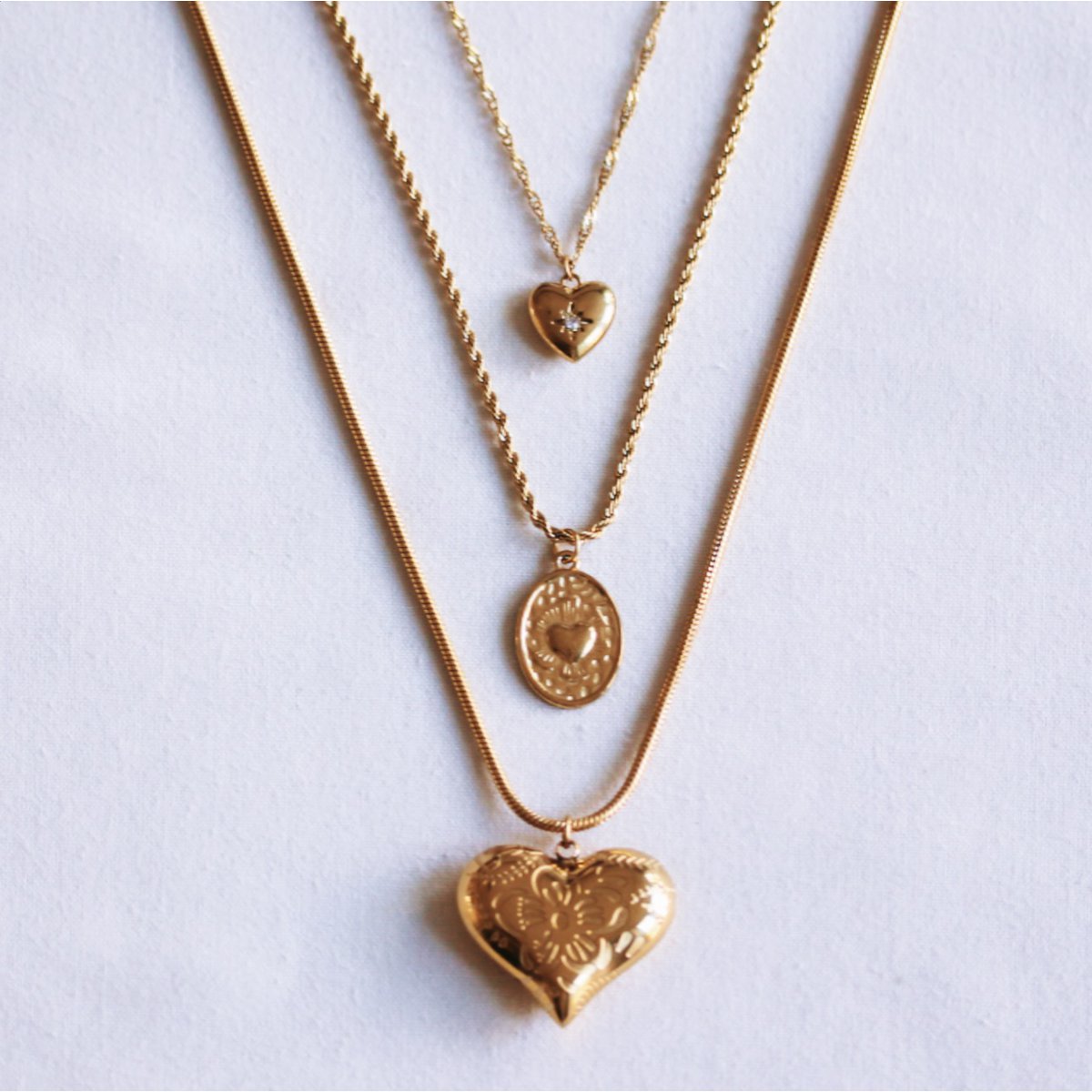Twisted steel chain with an oval heart charm