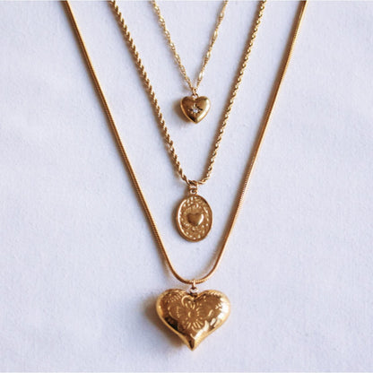 Twisted steel chain with an oval heart charm