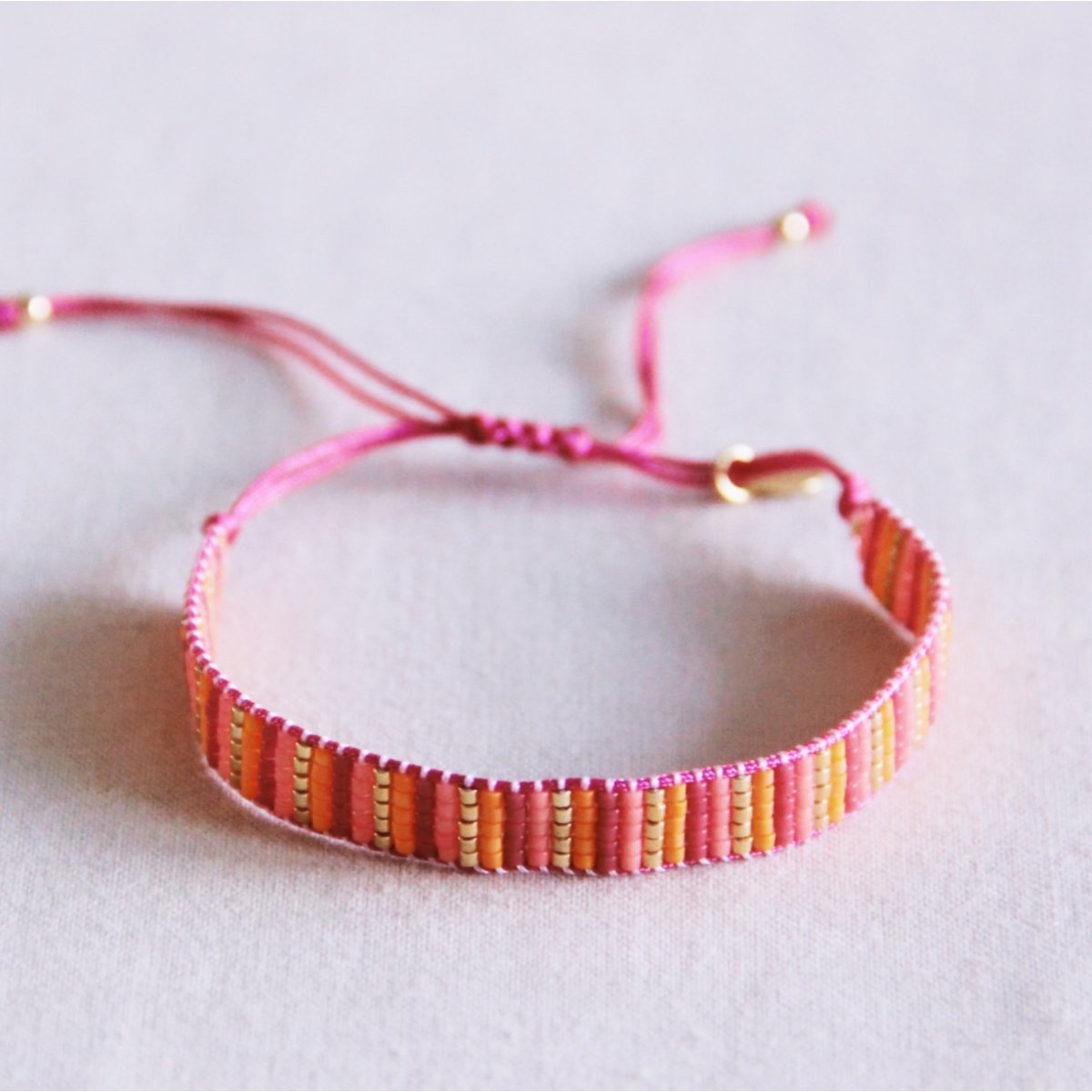 Stripes woven bracelet - pink/orange