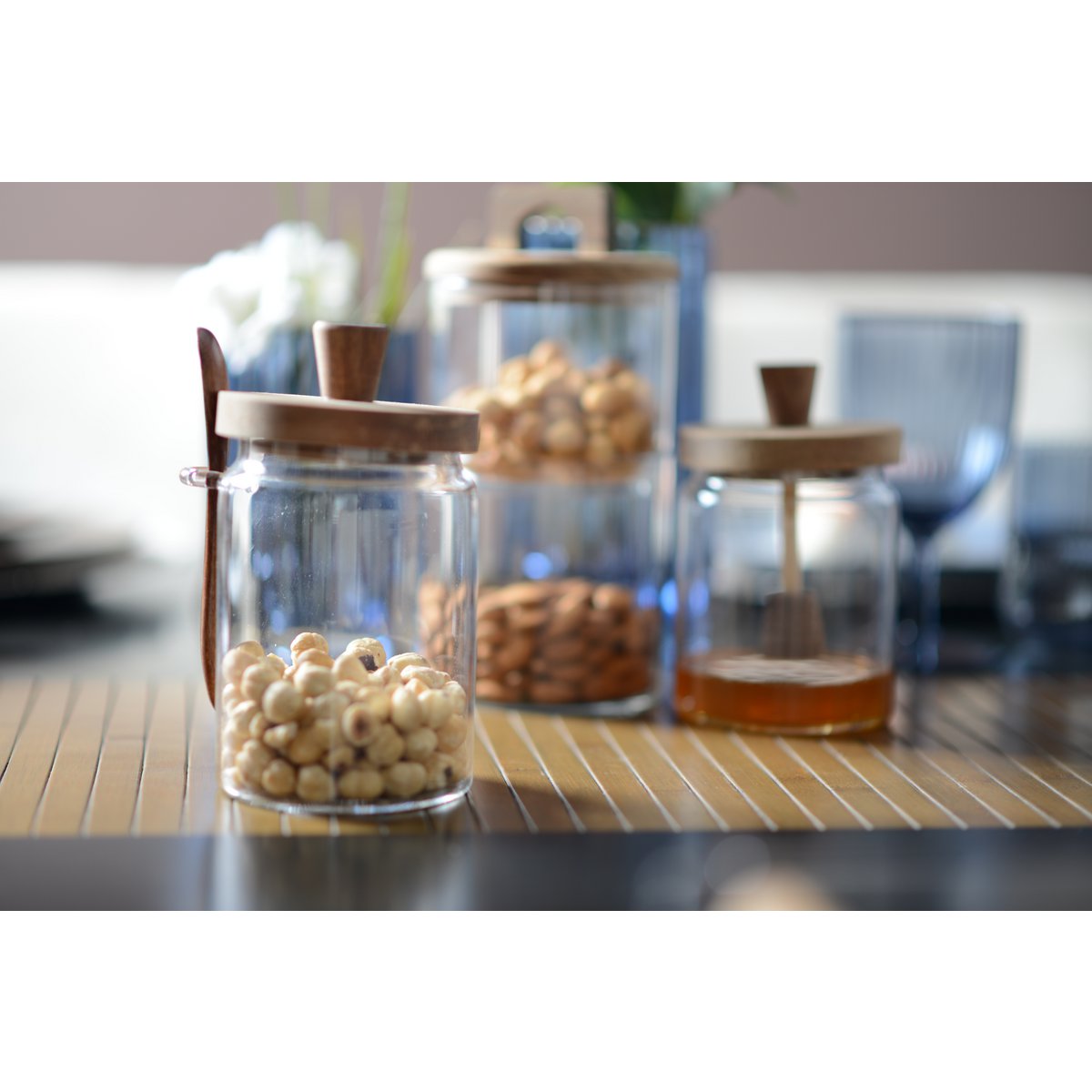 Glass sugar jar with wooden cover and spoonful