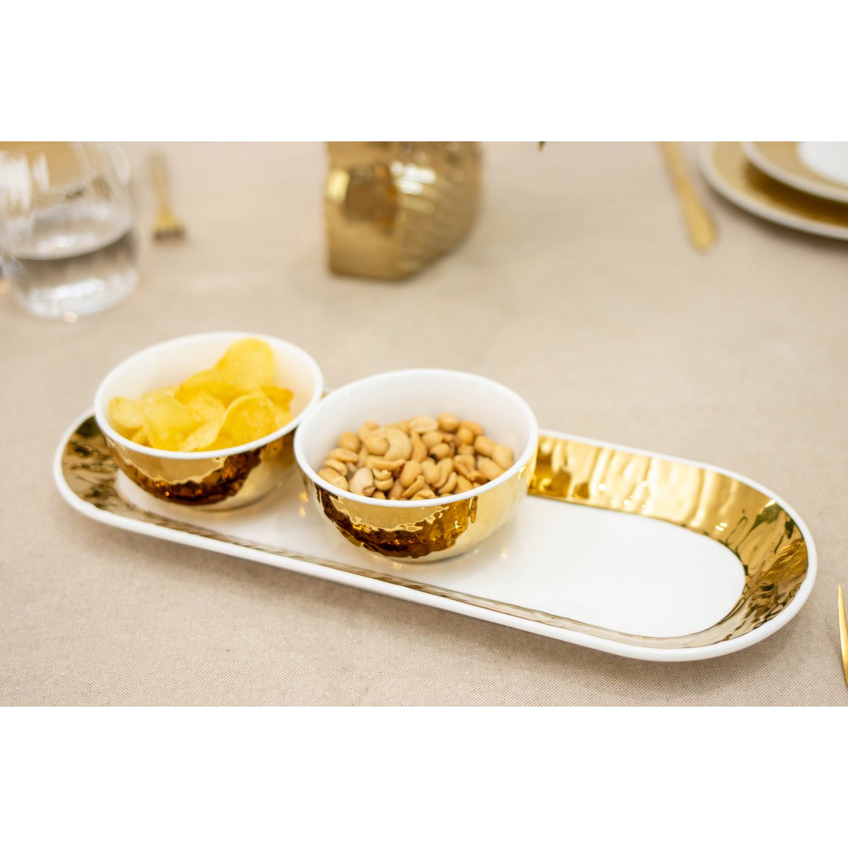 Set of 3 white and golden cups on set