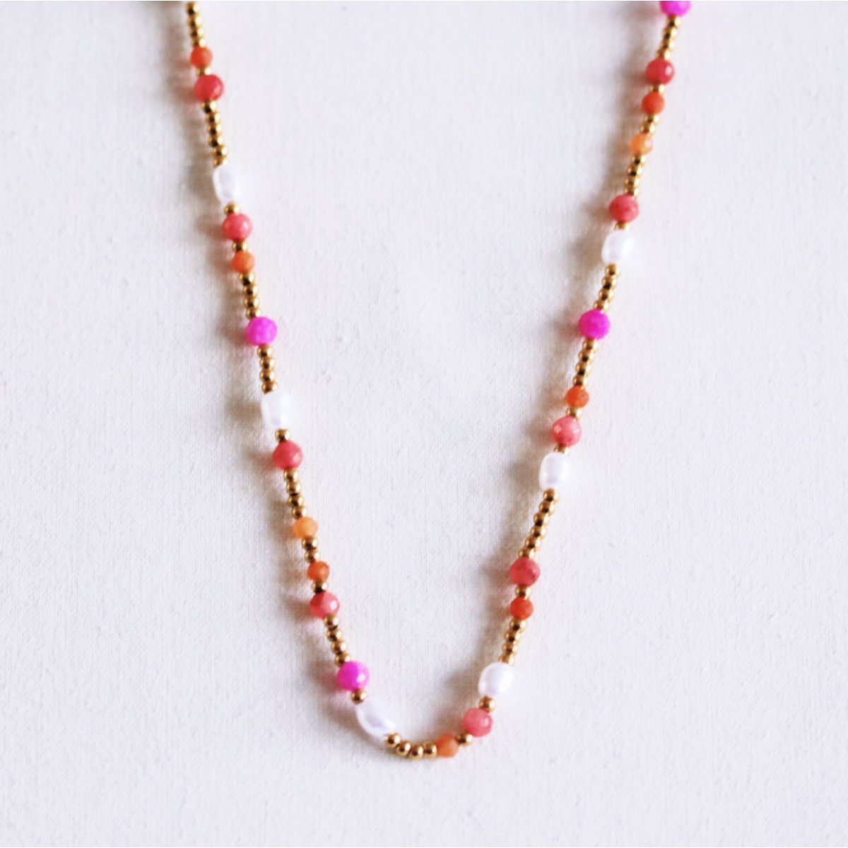 Beaded necklace with pearls and facets - coral/orange/pink