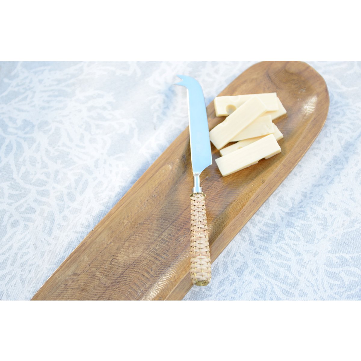 Beige cheese knife with wicker handle