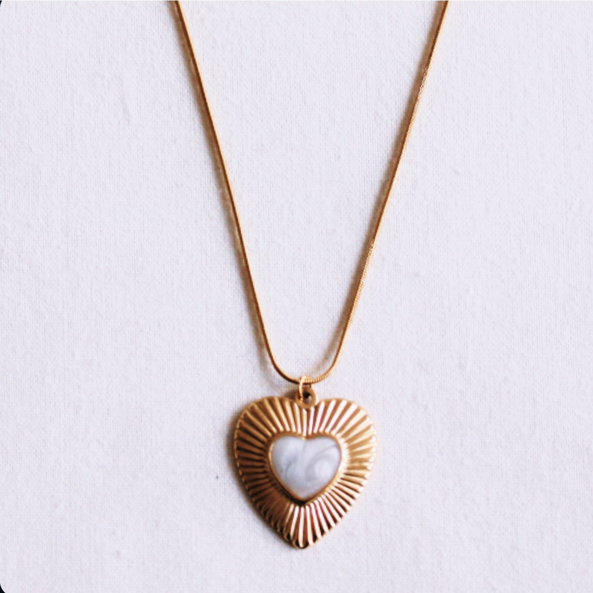 Long, fine snake chain with a mother-of-pearl heart