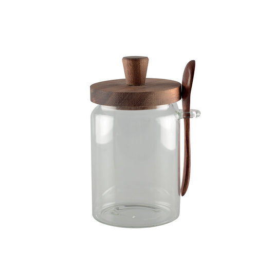 Glass sugar jar with wooden cover and spoonful