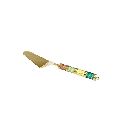 Golden pie server with multicolored braided handle