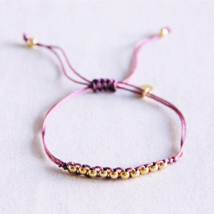 Satin bracelet with gold-colored beads - lilac