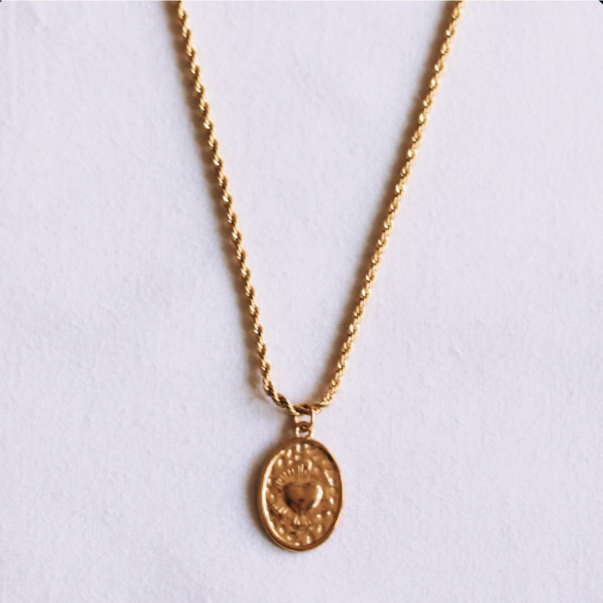 Twisted steel chain with an oval heart charm