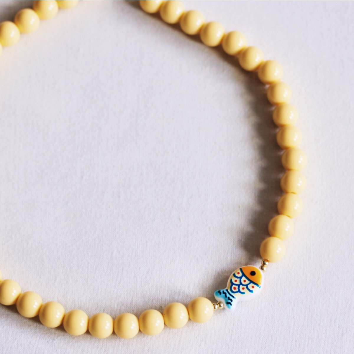 Beaded necklace with fish - yellow
