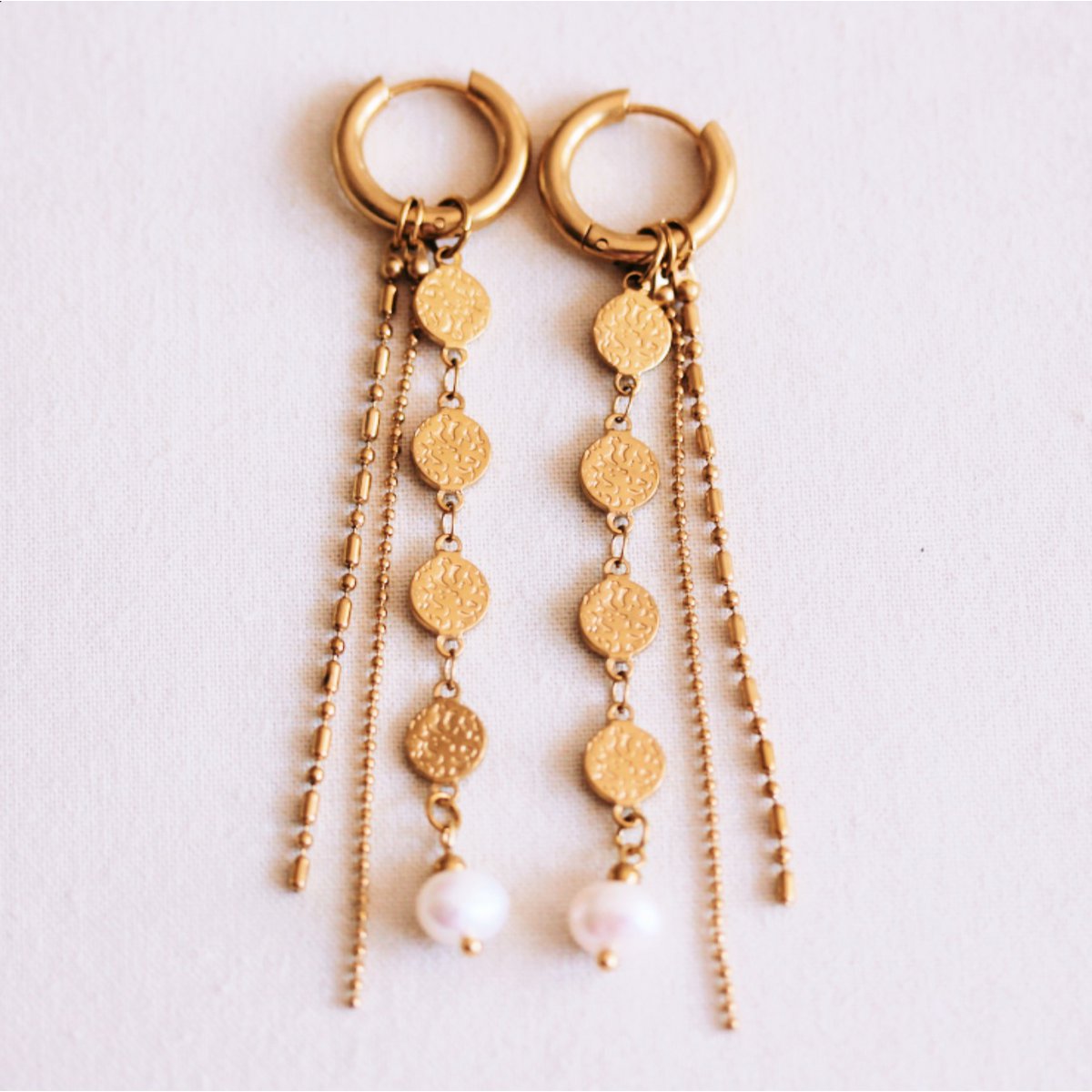 Stainless steel hoop earring with coins, pearl, and strings