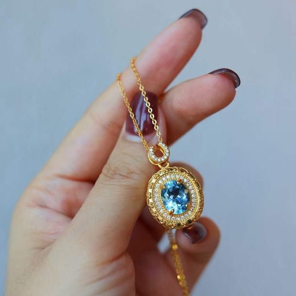 Blue Topaz Gold Framed Oval Pendant Necklace