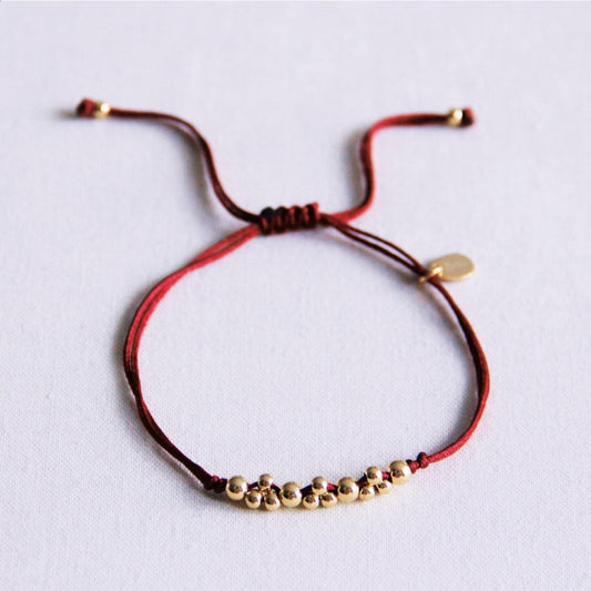 Satin bracelet with gold-colored beads - burgundy