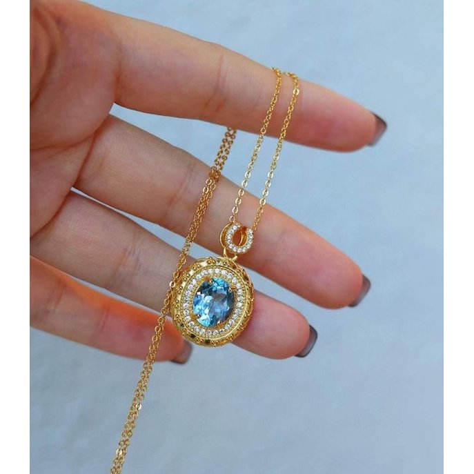 Blue Topaz Gold Framed Oval Pendant Necklace
